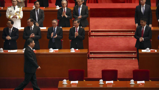 President Xi (bottom left) told the crowd of party members and successful Chinese identities that the country's policies would not be dictated by any other country.