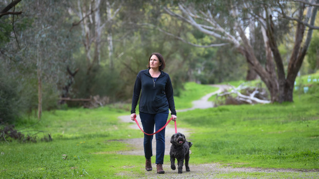 Manningham Council mayor Paula Piccinini takes Daisy the dog for a walk through Bulleen Park, which is under dispute.