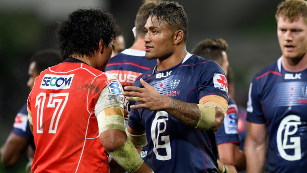 Before court: Amanaki Mafi shakes hands with a Sunwolves player after the Rebels' home game on May 25. 