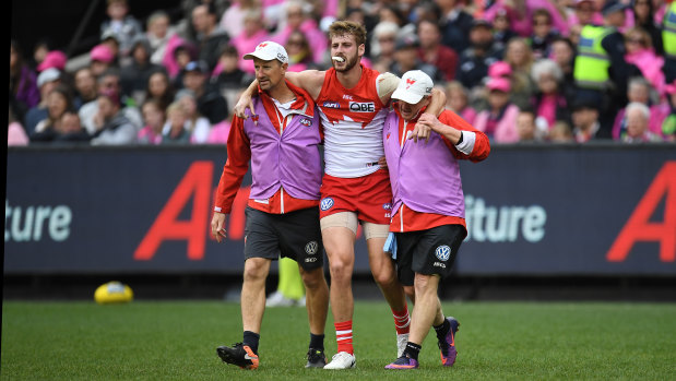 Agony: Alex Johnson is helped off the field with an ACL injury.