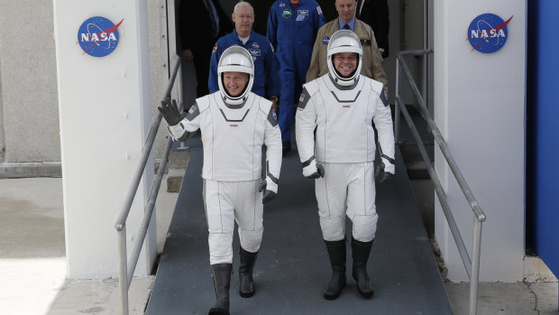 NASA astronauts Douglas Hurley, left, and Robert Behnken wave as they make their their way to Pad 39-A, at the Kennedy Space Centre in Cape Canaveral, Florida. 