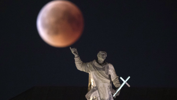 The moon turns red during a total lunar eclipse, as seen from Dresden, Germany.