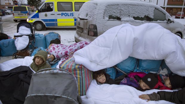 Migrant children  from Syria sleep outside the Swedish Migration Agency's offices, in Marsta, Sweden, in 2016. Sweden has since clamped down on what were some of the world's most open migration policies.