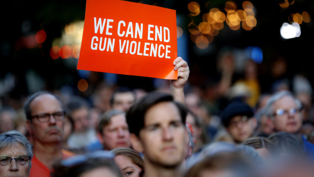 Mourners gather for a vigil at the scene of a mass shooting, Sunday, in Dayton, Ohio.