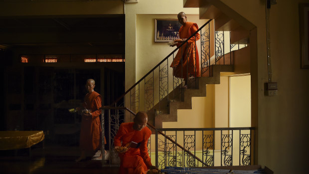 Female  monks descend from the prayer hall after a ceremony.