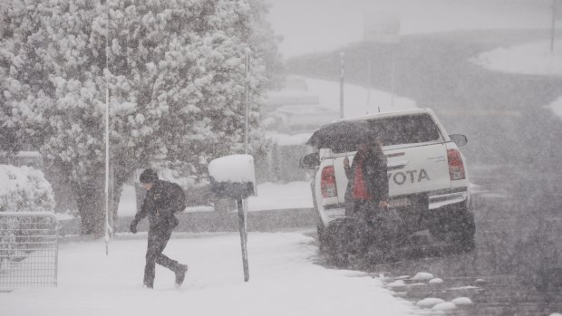 A child runs through snow to school in Black Springs in the NSW Central Tablelands on Friday.