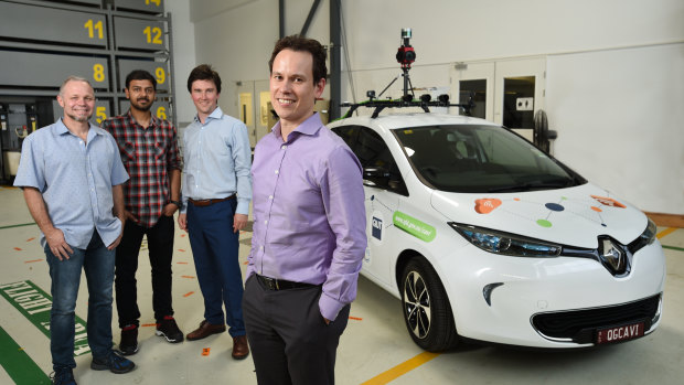 Sourav Garg (second from left) and QUT Professor Michael Milford (front) with the Zoe vehicle which is trialling autonomous vehicle sensors and cameras.