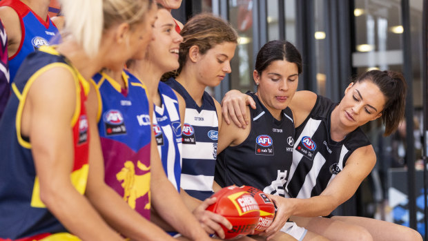 AFLW players attend a launch last year of a four-year broadcast deal with Foxtel and Seven.