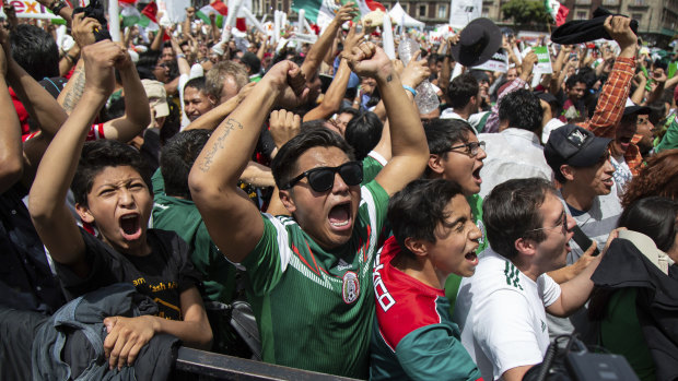 Fans celebrate as Mexico go on to win against reigning world champion Germany.