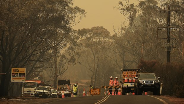 A police road block on Wilson Road between Buxton and Balmoral. The road has been closed due to the Green Wattle Creek fire.