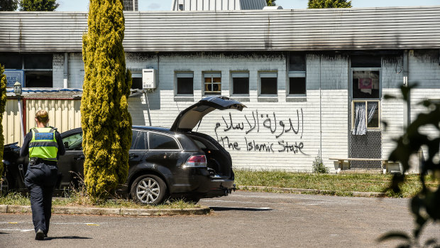 Police investigate the mosque fire.