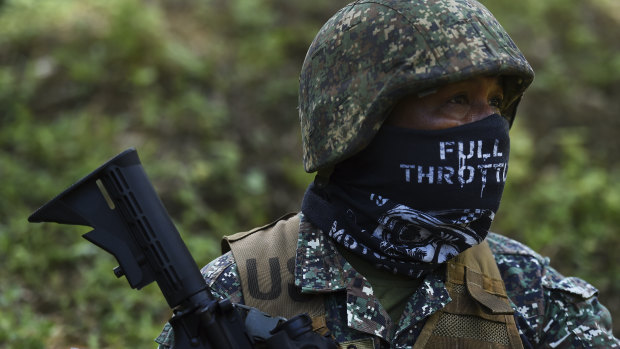 A Filipino marine pauses during firing during urban combat shooting at a firing range in Palawan, the Philippines.