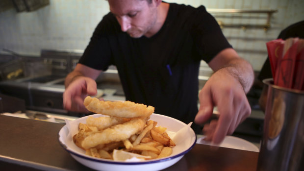 Patrons enjoy fresh fish and chips from The Fish Joint' Cafe at Brighton Le Sands.