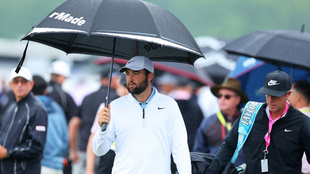 Scottie Scheffler and his caddie, Ted Scott, walk on the driving range at Valhalla Golf Club.