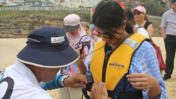 Migrants receive a lesson in beach safety at Tamarama.