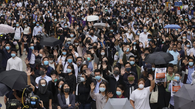 Protesters hold up their hands to represent their five demands as protests continue in Hong Kong on Tuesday.