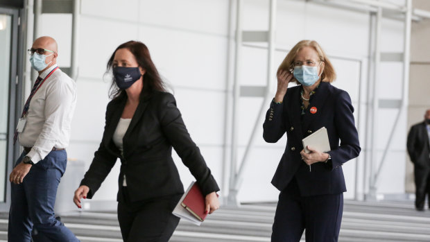 Queensland’s Health Minister Yvette D’Ath and Chief Health Officer Jeannette Young arrive at Monday’s media conference in the Brisbane Convention and Exhibition Centre.