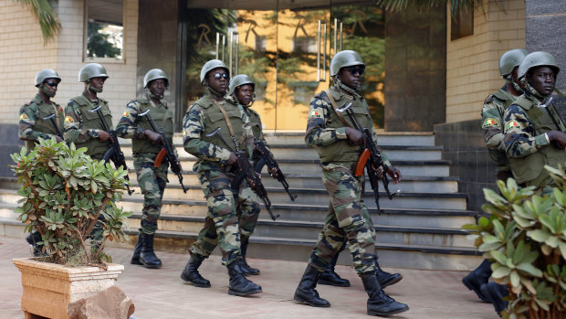 Soldiers from the Burkina Faso presidential guard patrol outside the Radisson Blu hotel in Bamako which was attacked in 2015.