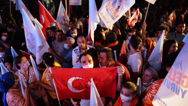 Supporters of the newly elected Turkish Cypriot leader Ersin Tatar hold a Turkish flag in the Turkish occupied area in the north part of the divided capital Nicosia after the election.
