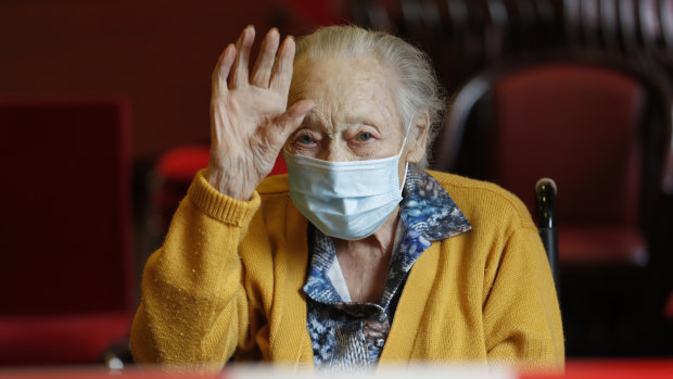 Marguerite Mouille, 94, waves goodbye to her daughter at the Kaisesberg nursing home, eastern France.