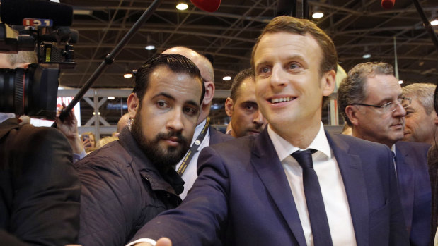 Emmanuel Macron, center, flanked by his bodyguard, Alexandre Benalla, left, visits the Agriculture Fair in Paris last year.