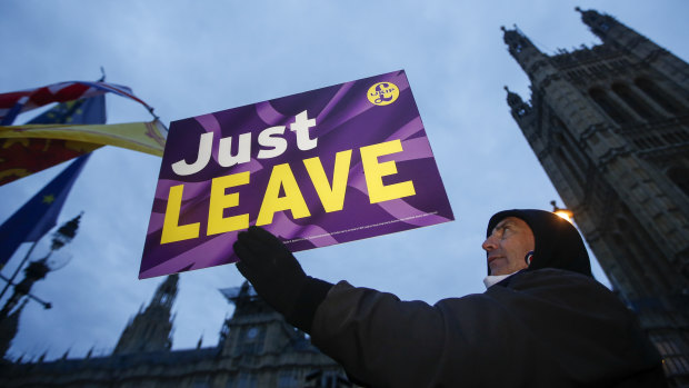 A pro-Brexit demonstrator holds a 'Just Leave' sign outside the House of Parliament in London on Tuesday. The tables have turned in favour of the UK.
