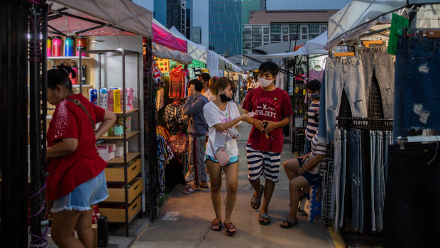 People browse the newly reopened Rot Fai Market in Bangkok, Thailand.