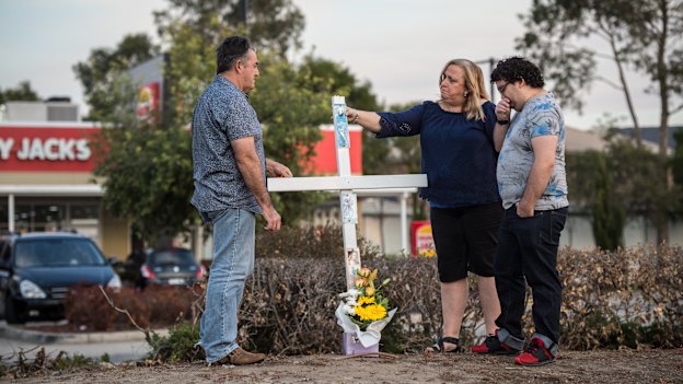 Ron and Leesa Topic, along with oldest son Kris, gather at the site where their daughter and sister Courtney died. 