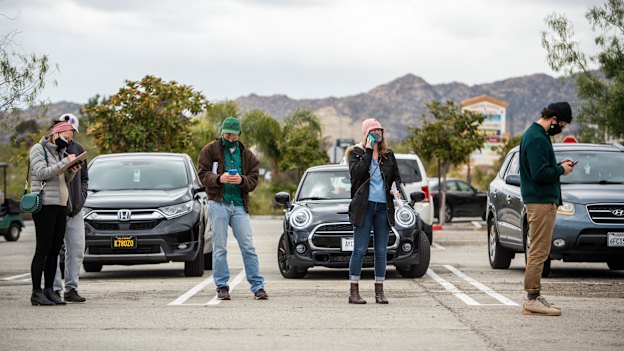 In California, people stand in a church carpark to wait for vaccines from a pop-up clinic in March. 