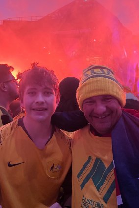 Benjamin (left) and his dad Michael at Fed Square, ready to watch the Socceroos take on Argentina