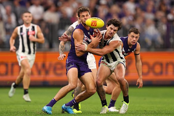 Heath Chapman of the Dockers and Lachie Schultz of the Magpies contest for the ball.