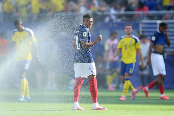 Kylian Mbappe #10 of France cools off during a hydration break.