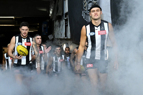 Captain Darcy Moore leading out Collingwood.