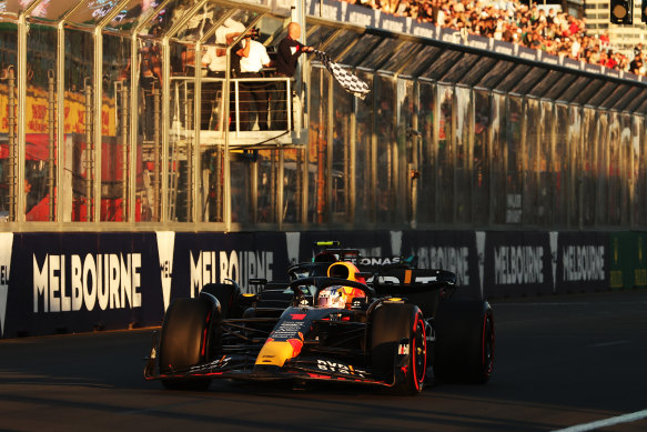 Max Verstappen takes the chequered flag as the sun sinks at the Grand Prix on Sunday.