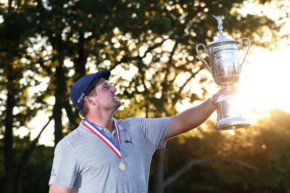 Bryson DeChambeau poses with his first major trophy.