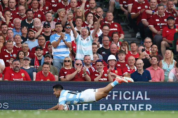 Argentina’s Tomas Albornoz dives over the line to score a try.