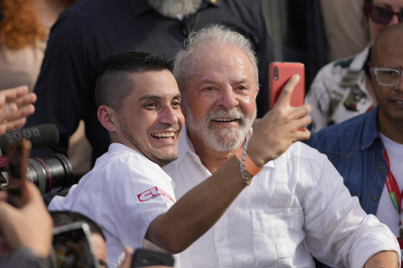 Brazil’s former President Luiz Inacio Lula da Silva, who is running for reelection, takes a selfie with a supporter during a campaign rally in Sao Bernardo do Campo, SP.