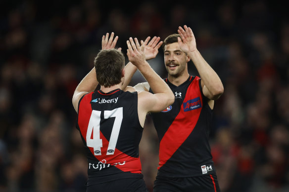 Essendon celebrate a goal against Adelaide.