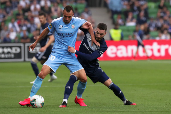 City's Florin Berenguer holds off Victory's Storm Roux during his impressive showing in the Melbourne derby at AAMI Park on Friday night.