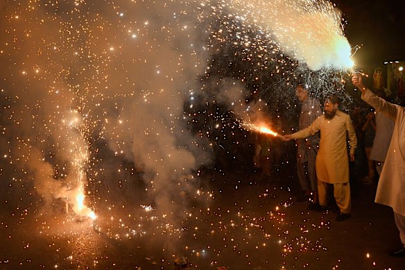 People light fireworks to celebrate Pakistan and India reaching a ceasefire deal.