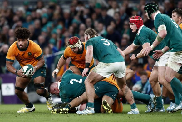Australia’s Rob Valetini, left, runs with the ball against Ireland