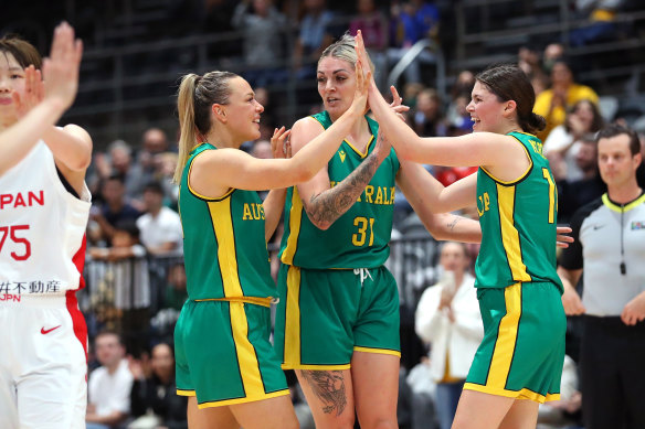 Tess Madgen, Cayla George and Jade Melbourne celebrate the Opals’ win over Japan.