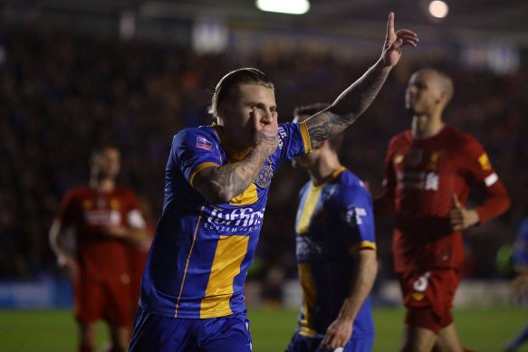 Jason Cummings celebrates Shrewsbury Town's first goal as the League One side came from 2-0 down to force an FA Cup replay against Liverpool.