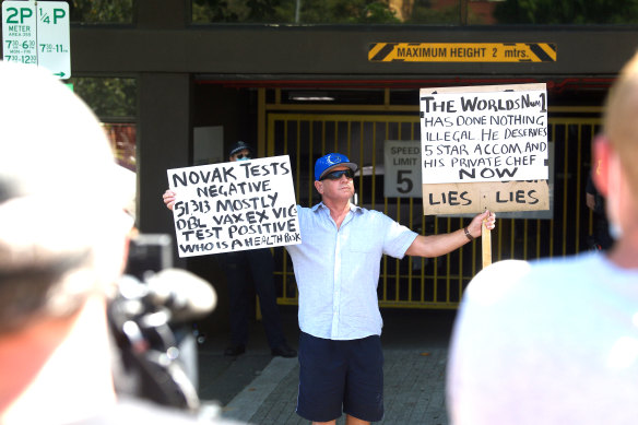 A protester outside the Park Hotel in Carlton, where the tennis’ world number one is being detained.