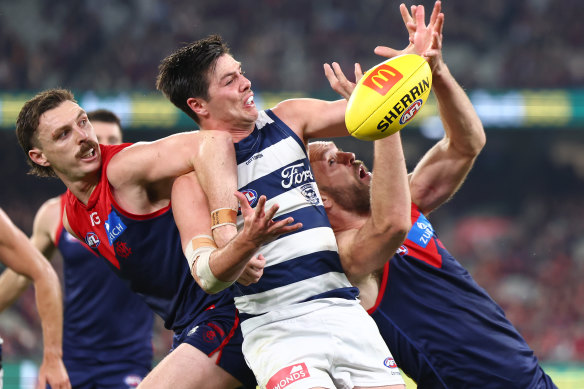 Oliver Henry of the Cats competes for a mark against Max Gawn of the Demons.