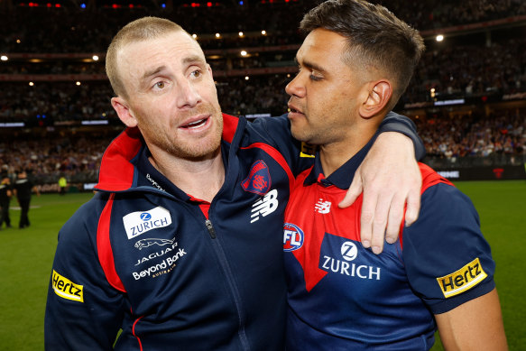 Neville Jetta with Melbourne’s senior coach Simon Goodwin after the drought-breaking premiership.
