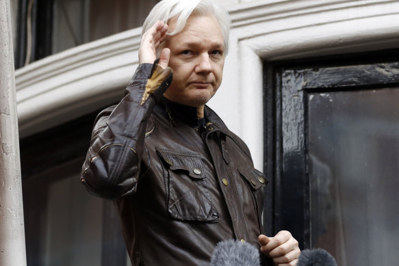 WikiLeaks founder Julian Assange greets supporters from a balcony of the Ecuadorian embassy in London back in 2017.