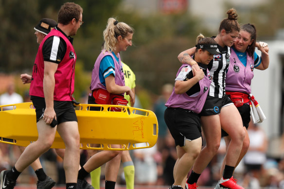 Magpie Brianna Davey leaves the field injured.