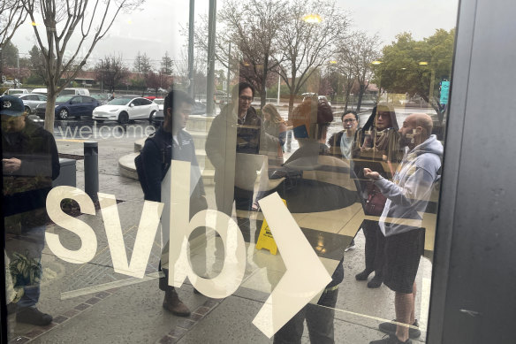 People line up outside the Silicon Valley Bank headquarters on Friday after it was shut down by California regulators.