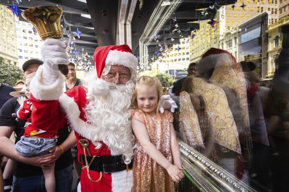 Santa Claus meets children at the  Myer Christmas windows in Bourke Street Mall.